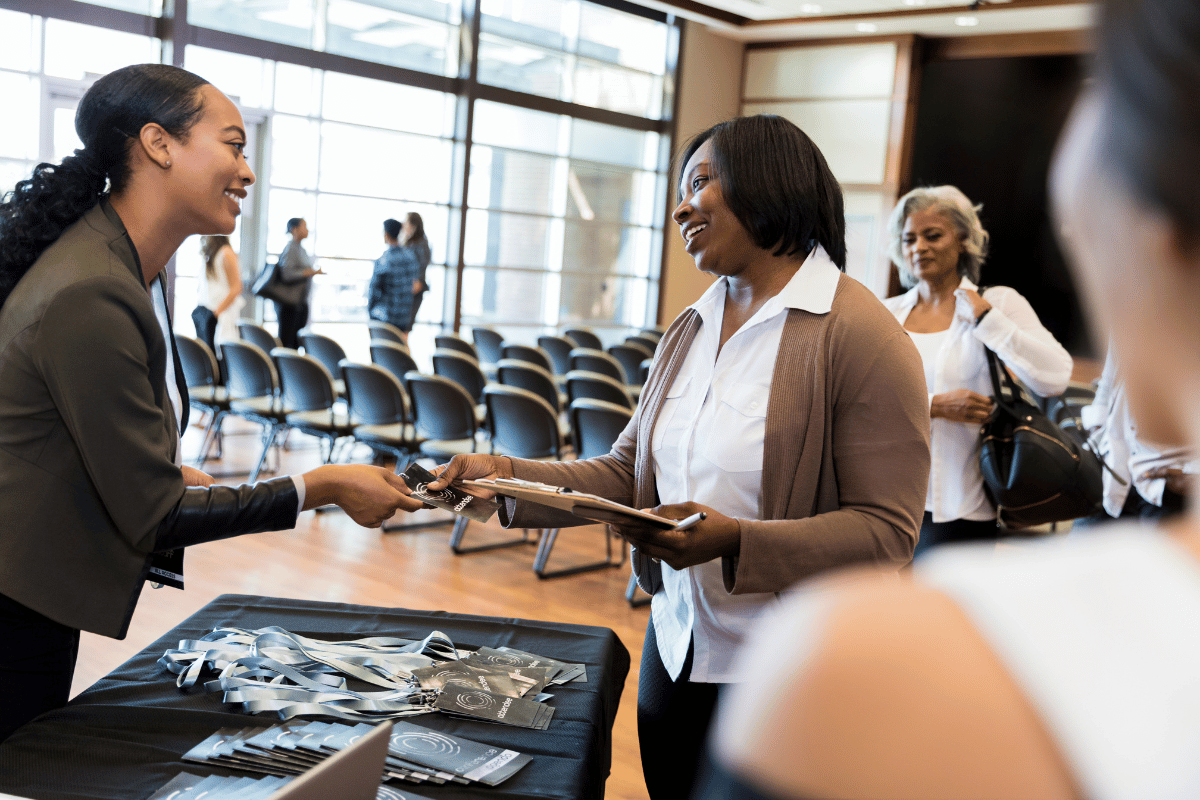 Lady providing lanyards at event