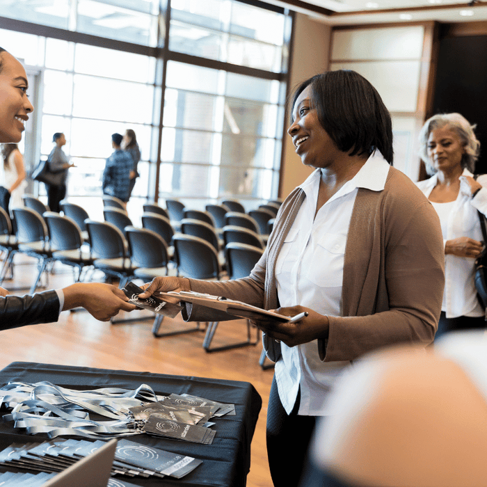 Lady providing lanyards at event