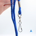 Holding royal blue cord lanyard with swivel clip